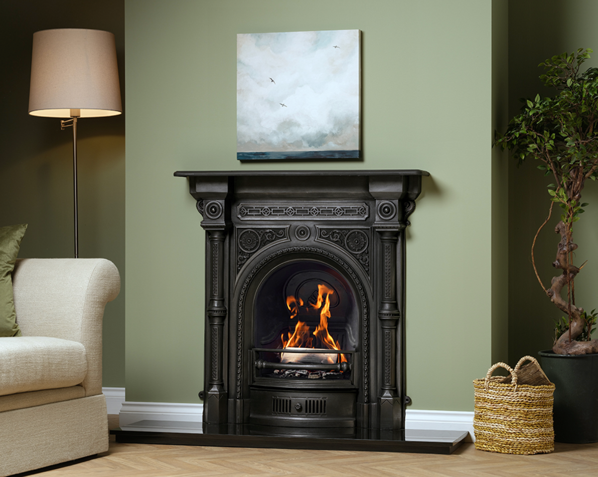 Carron Tweed cast iron combination fireplace with a lit fire in a sage green living room