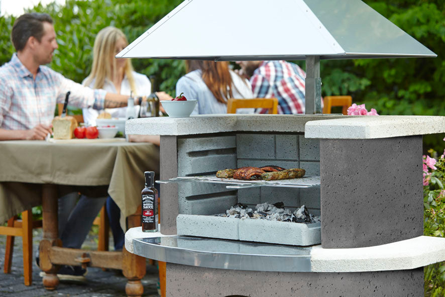 Buschbeck Zurich masonry barbecue in use in a garden