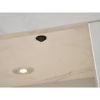 Close up of the downlight and switch in the Acantha chamber kit in white marble effect
