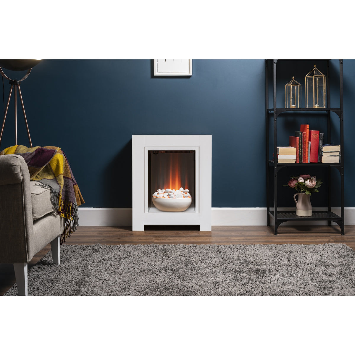Adam Monet pure white electric fireplace suite in a living room with a dark blue wall