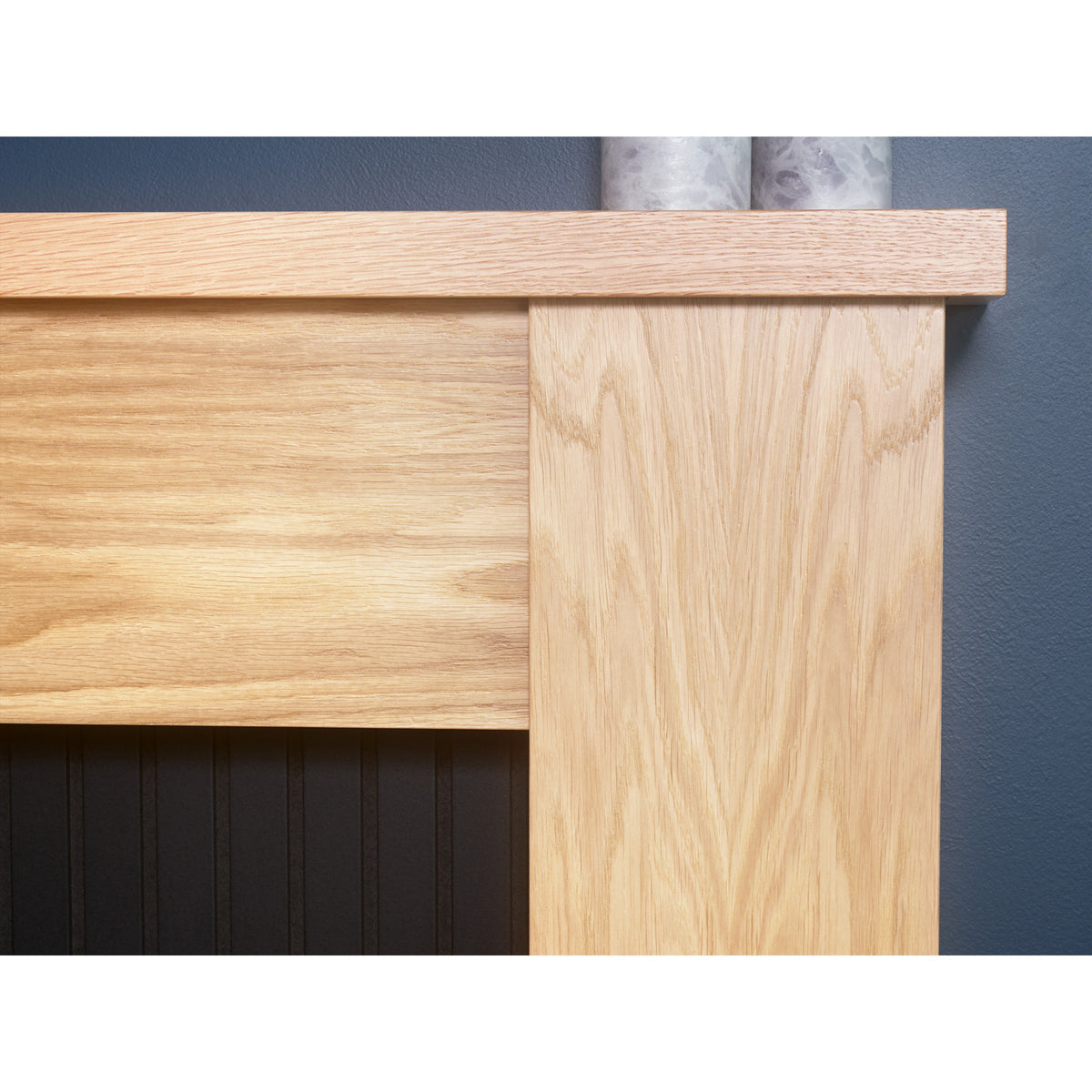 Close-up of the oak effect mantel on the Adam New England fireplace