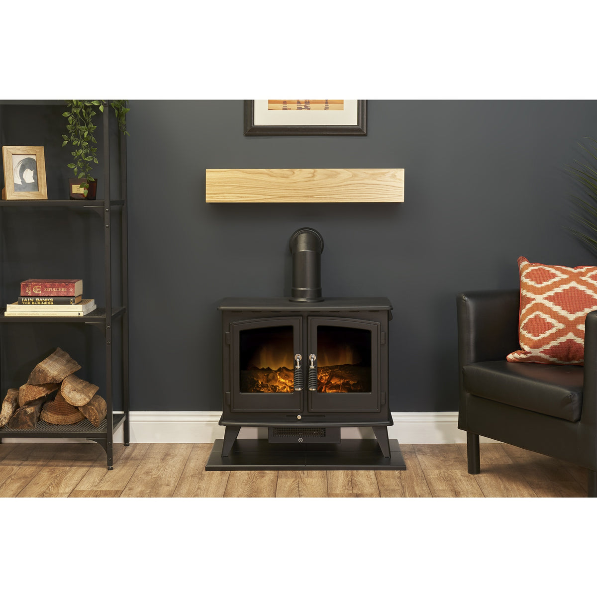 Adam Woodhouse electric stove in black on the black hearth below the oak effect beam