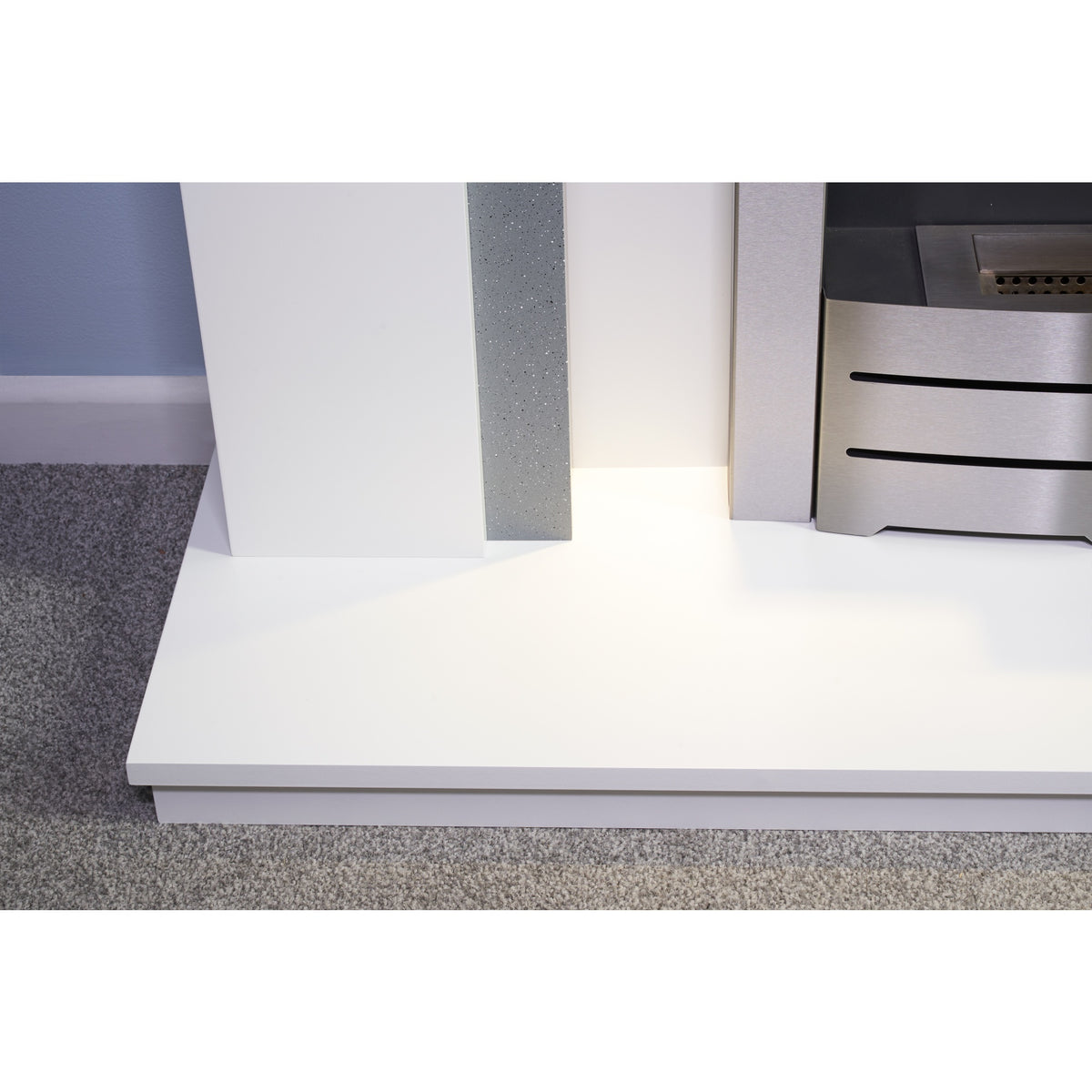 Close-up of the Adam Savanna hearth and the base of the brushed steel Colorado bioethanol fire