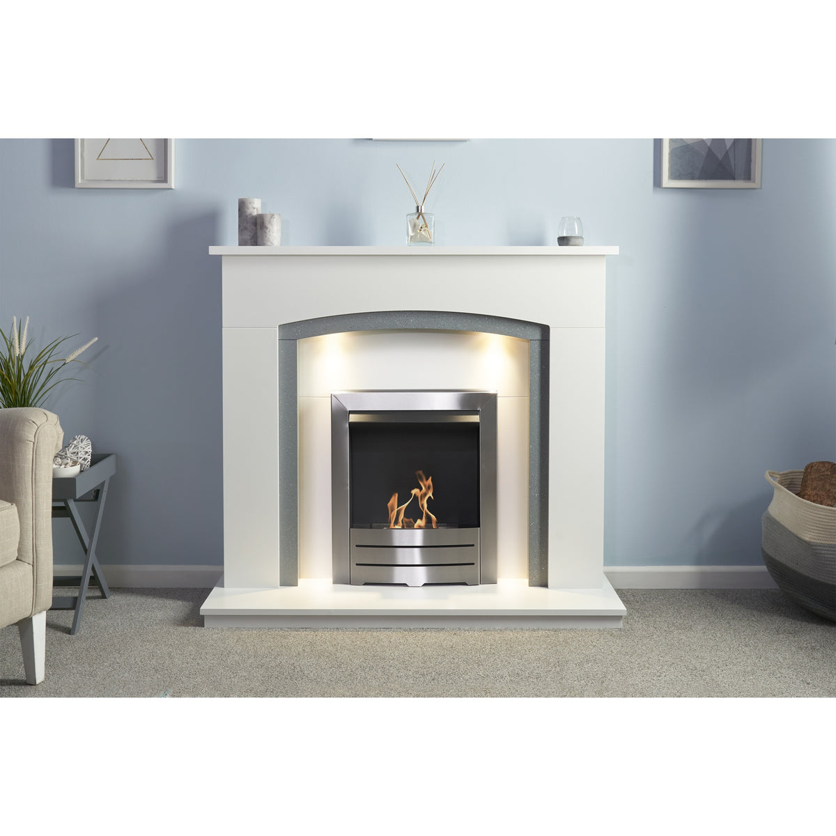 Adam Savanna bioethanol fireplace suite with downlights on in a living room