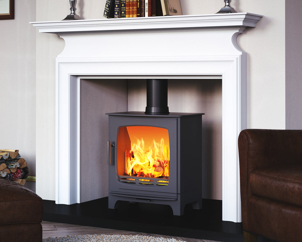 Carron ECO Revolution 5kW stove set in a fireplace with a white surround