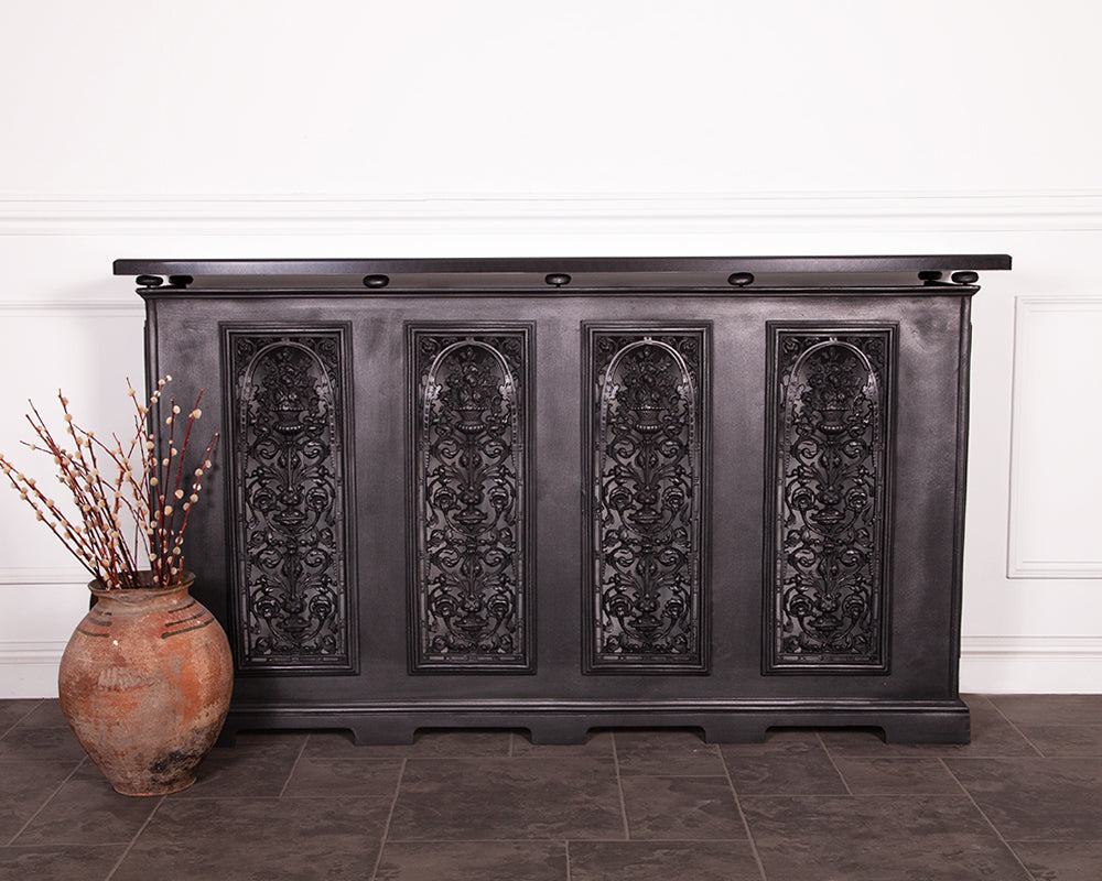 Carron cast iron 4 panel radiator cover in a room setting