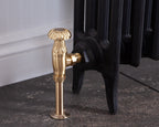Carron Crocus manual valve in brushed brass installed on a radiator