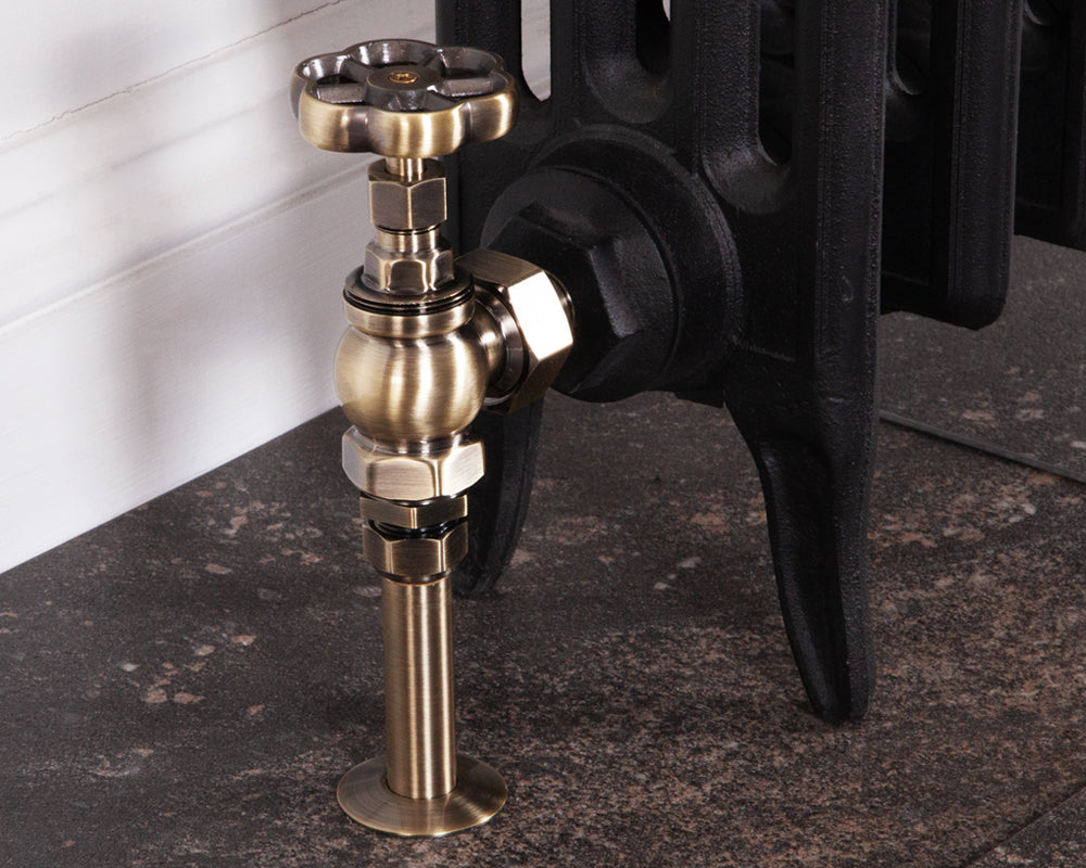 Carron Daisy wheel valve set in antique brass installed on a radiator