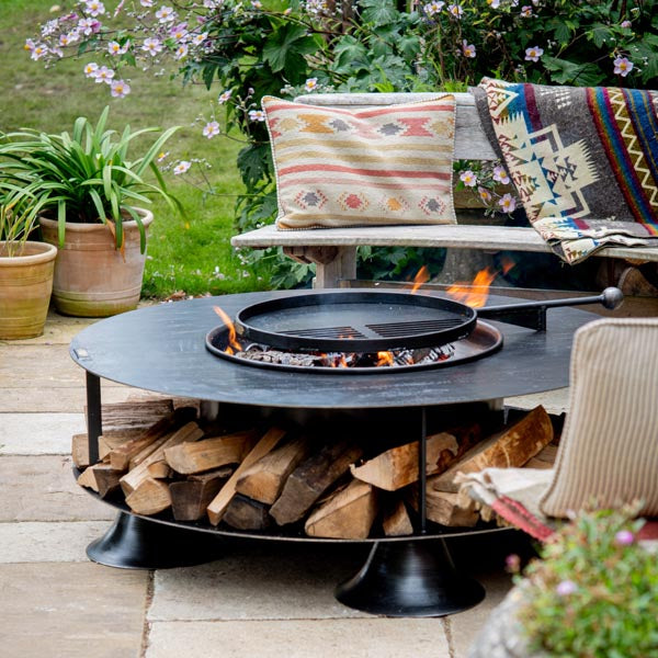 Flat Ring of Logs 120 with its swing arm BBQ rack over the fire