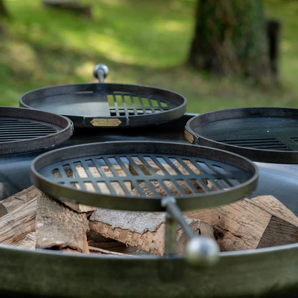 Close-up of the four swing arm BBQ racks on the Ring of Logs 120