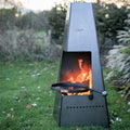 Firepits UK Piazza steel chiminea lit with the swing arm BBQ rack in the opening