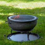 Firepits UK 2 in 1 Camping Pit lit with a grill in a garden