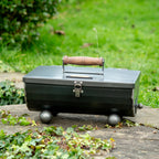 Pitnic portable BBQ closed with its wooden handle