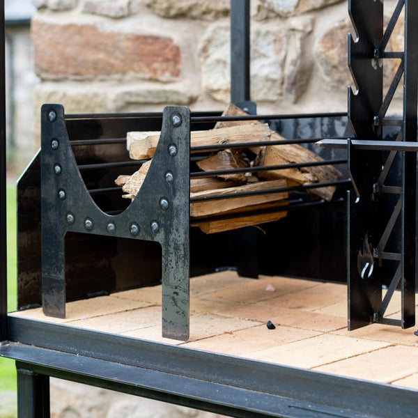 Close-up of the Asado Maximo wheeled grill and fire basket
