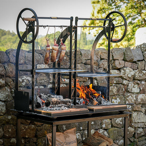 Firepits UK Katherine Wheel Dual BBQ lit with steaks on the grill