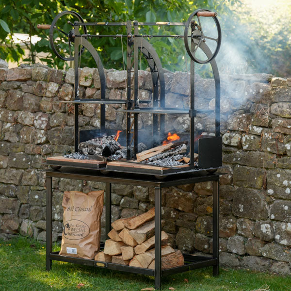 Katherine Wheel Dual BBQ on its stand with log storage underneath