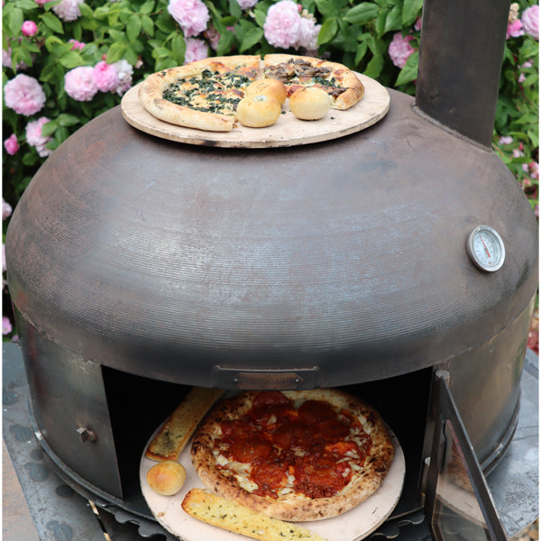 Two pizzas from the Dome Oven on the Complete Outdoor Kitchen worktop