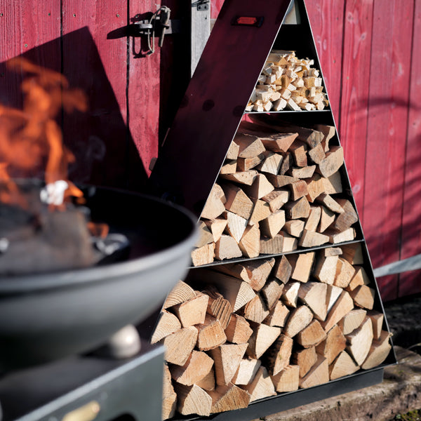 Pyramid log store beside a fire pit