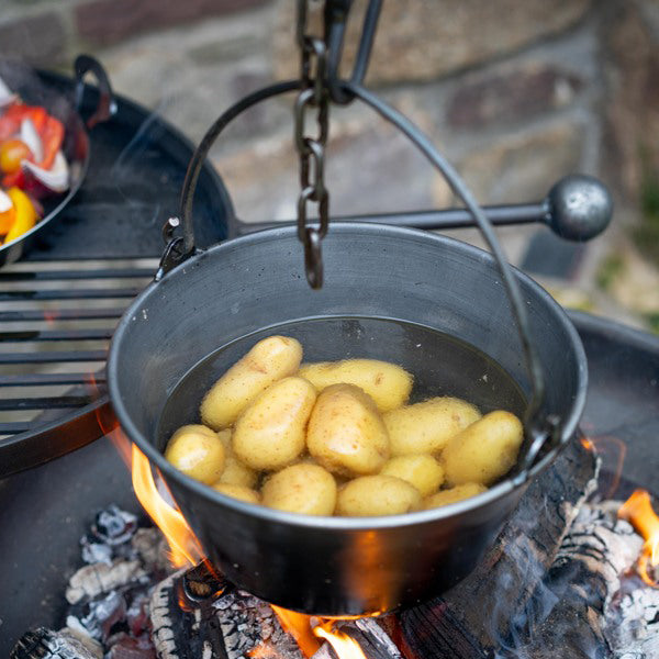 Potatoes cooking in the hanging cooking pot