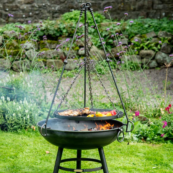 Firepits UK tripod cooking rack over a lit fire pit