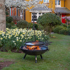 Tripod cooking rack sitting on a Celeste fire pit