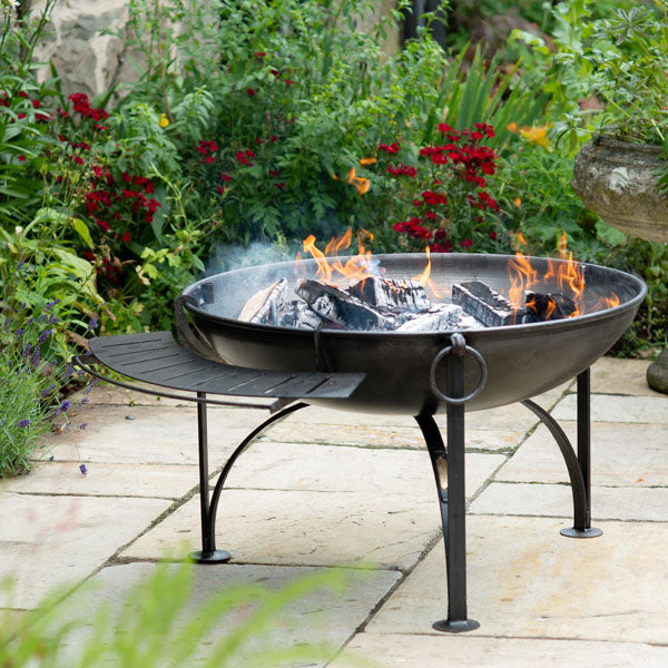 Fire pit shelf hung on a Plain Jane fire pit beside the swing arm rack