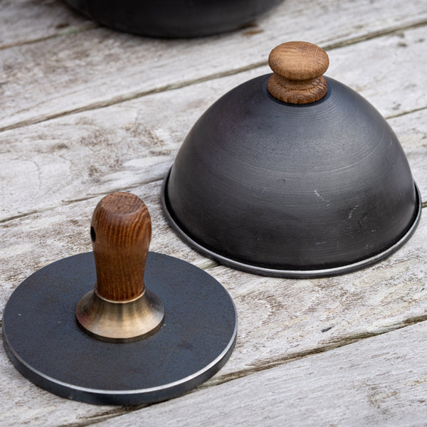 Firepits UK steel burger press and burger cloche on a table