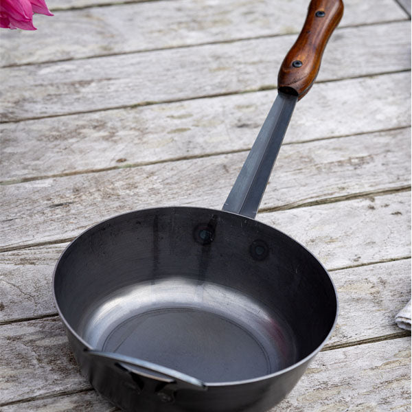 Firepits UK long handled saucepan on a table