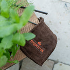 Brown suede gloves on a log store seat