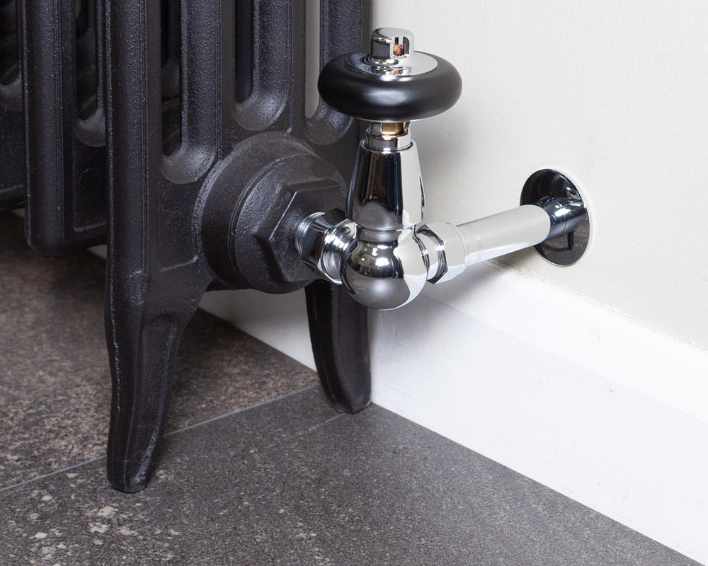 Carron Kingsgrove corner thermostatic valve in chrome installed on a radiator