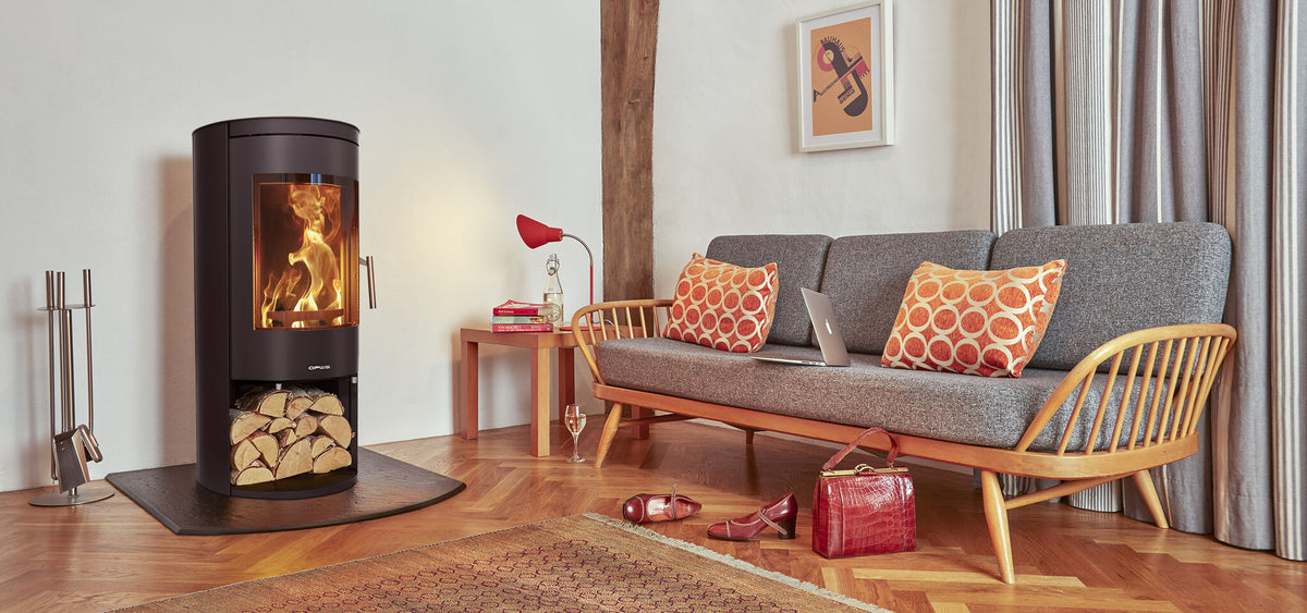 Opus Melody LS wood burning stove with open log store in a living room