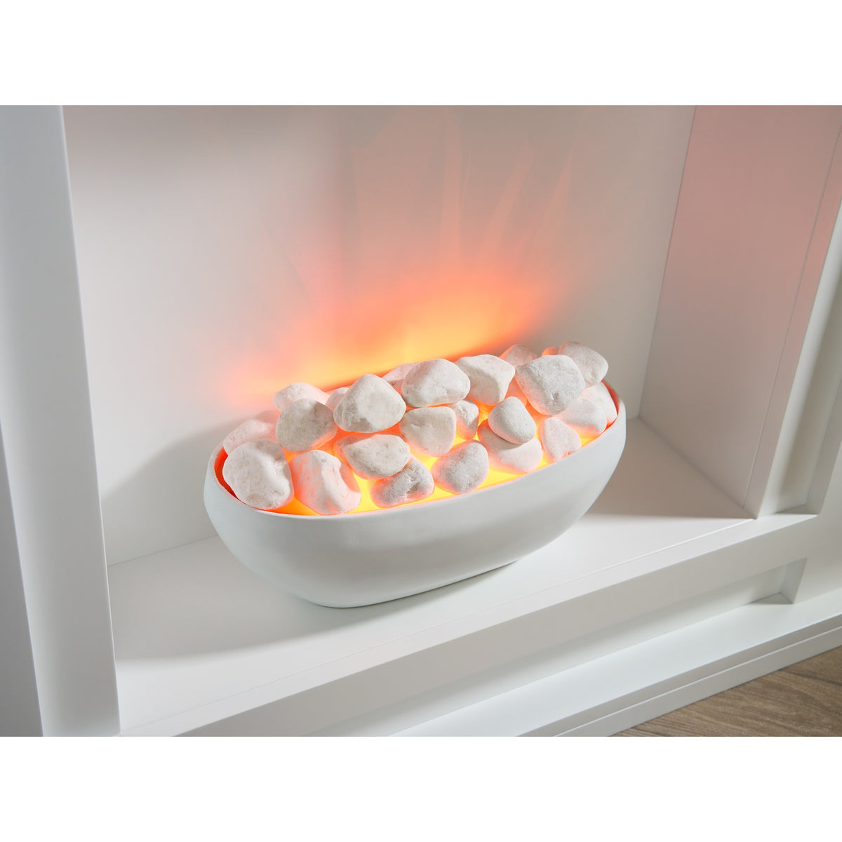 Close-up of the Sureflame Mondrian white bowl and white pebbles with the glow on